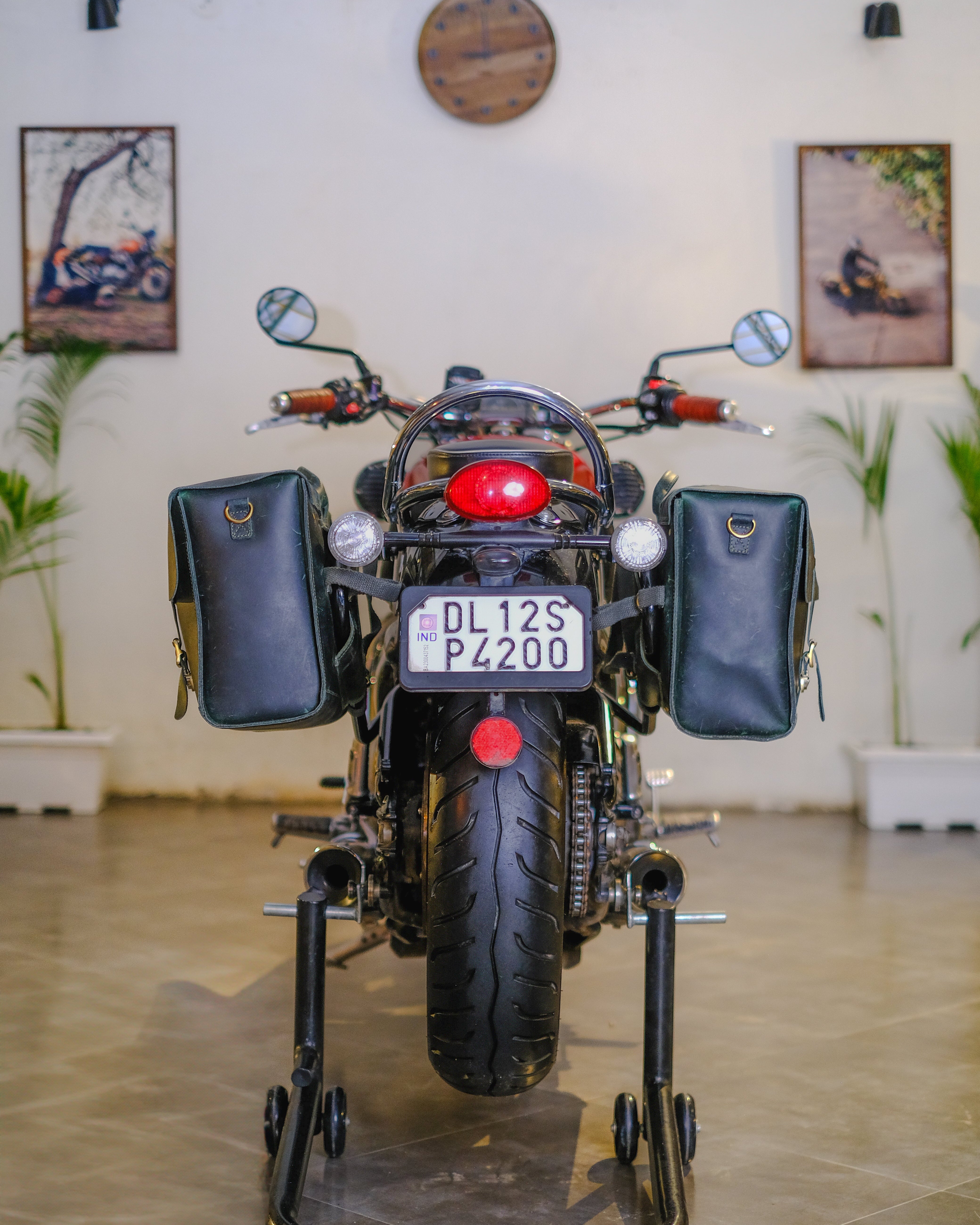 Motorcycle on a stand indoors with decorative elements in the background