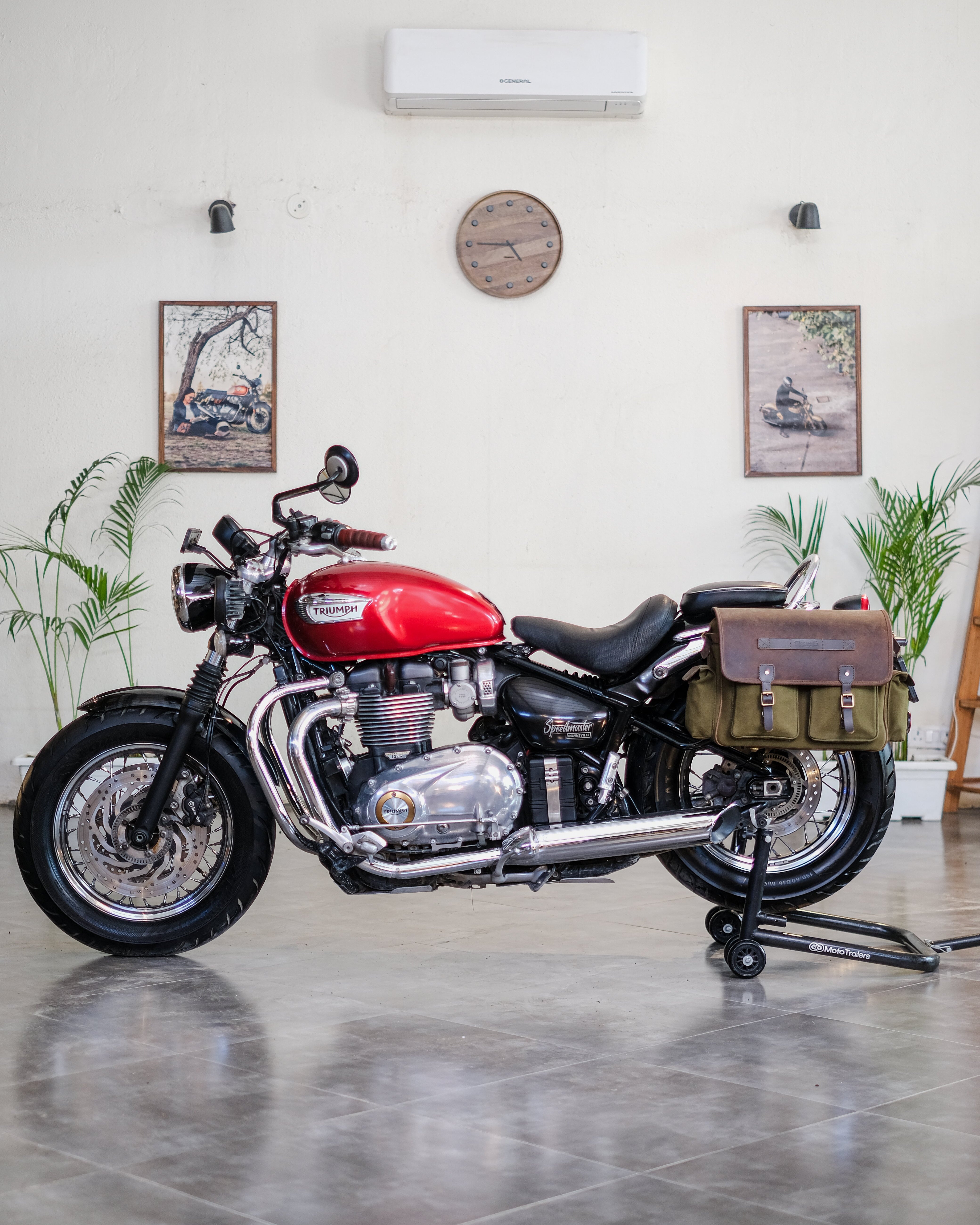 Red motorcycle indoors with a white wall and decor