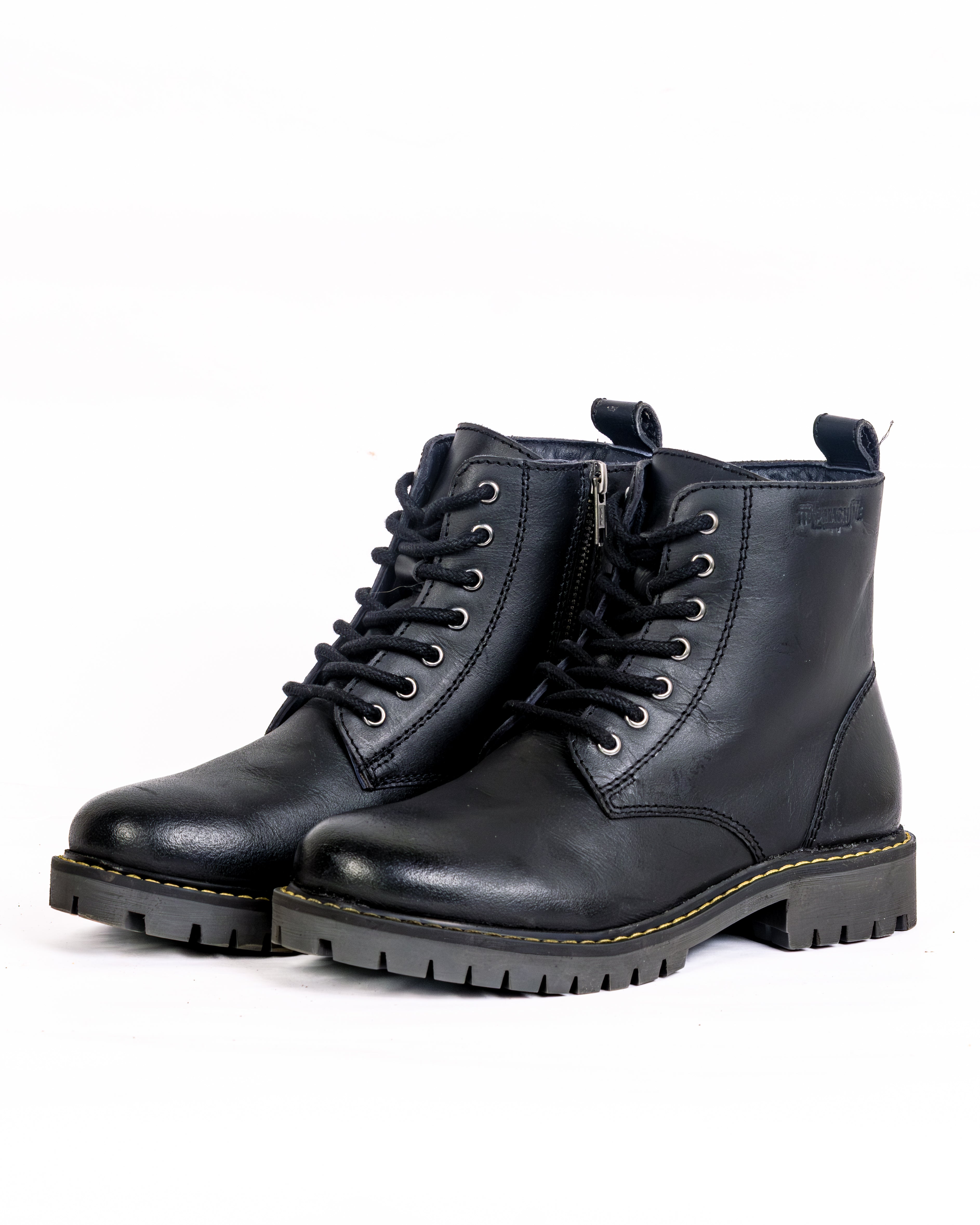 Pair of black leather boots on a white background