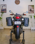 Motorcycle on a stand indoors with decorative elements in the background
