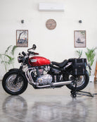 Red motorcycle in a room with Saddlebag on it