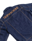 Blue denim jacket with 'TRIP MACHINE' branding on a white background