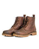 Pair of brown leather boots on a white background